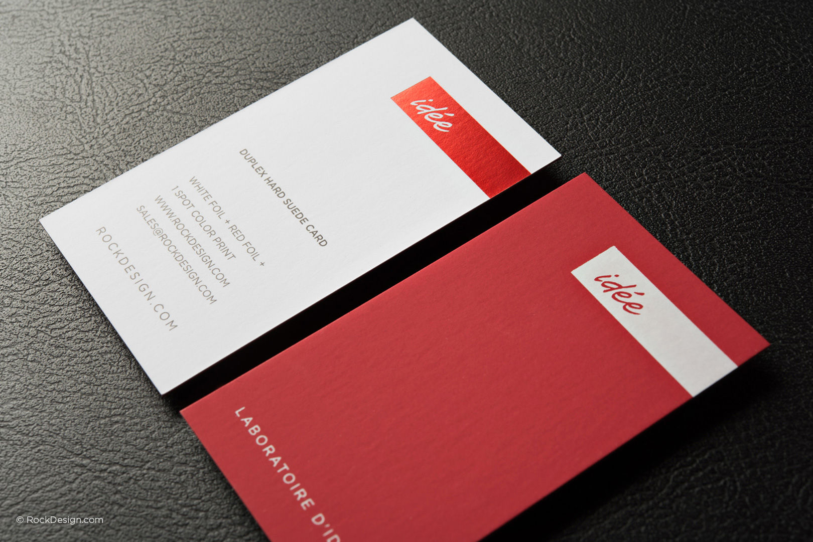 Luxury duplex hard suede business cards with red and white foil, featuring minimalist design for premium branding.